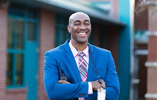 Administrator looking on while smiling